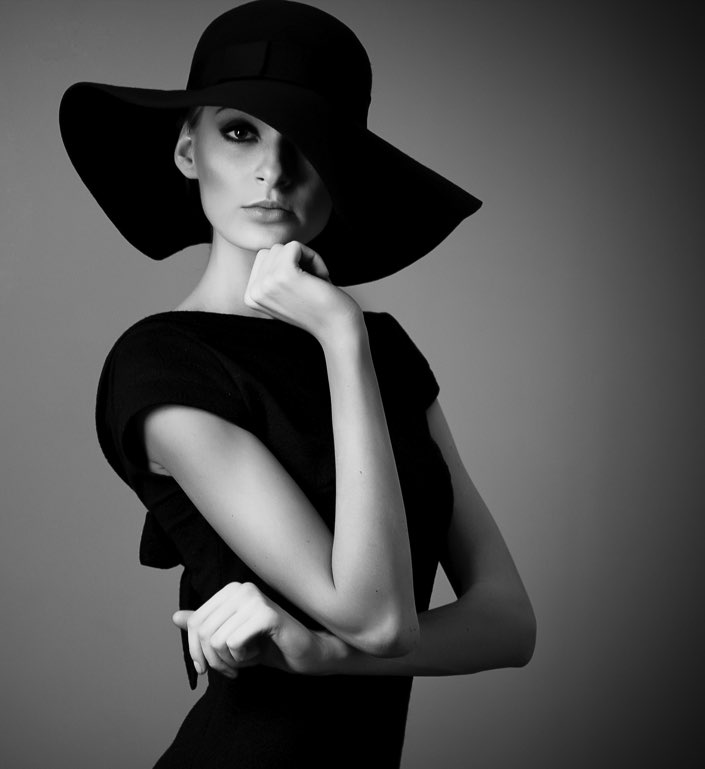Woman wearing black hat and black dress